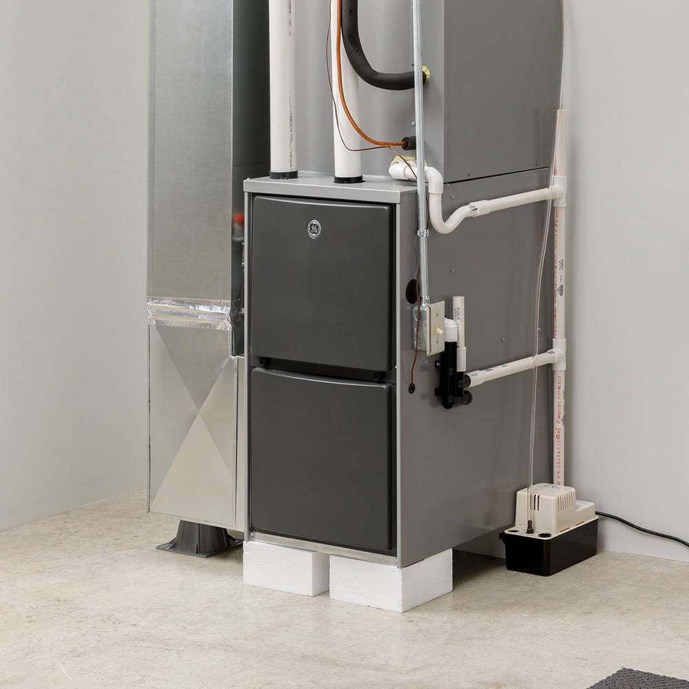 GE furnace and air handler installed with ductwork and condensate pump