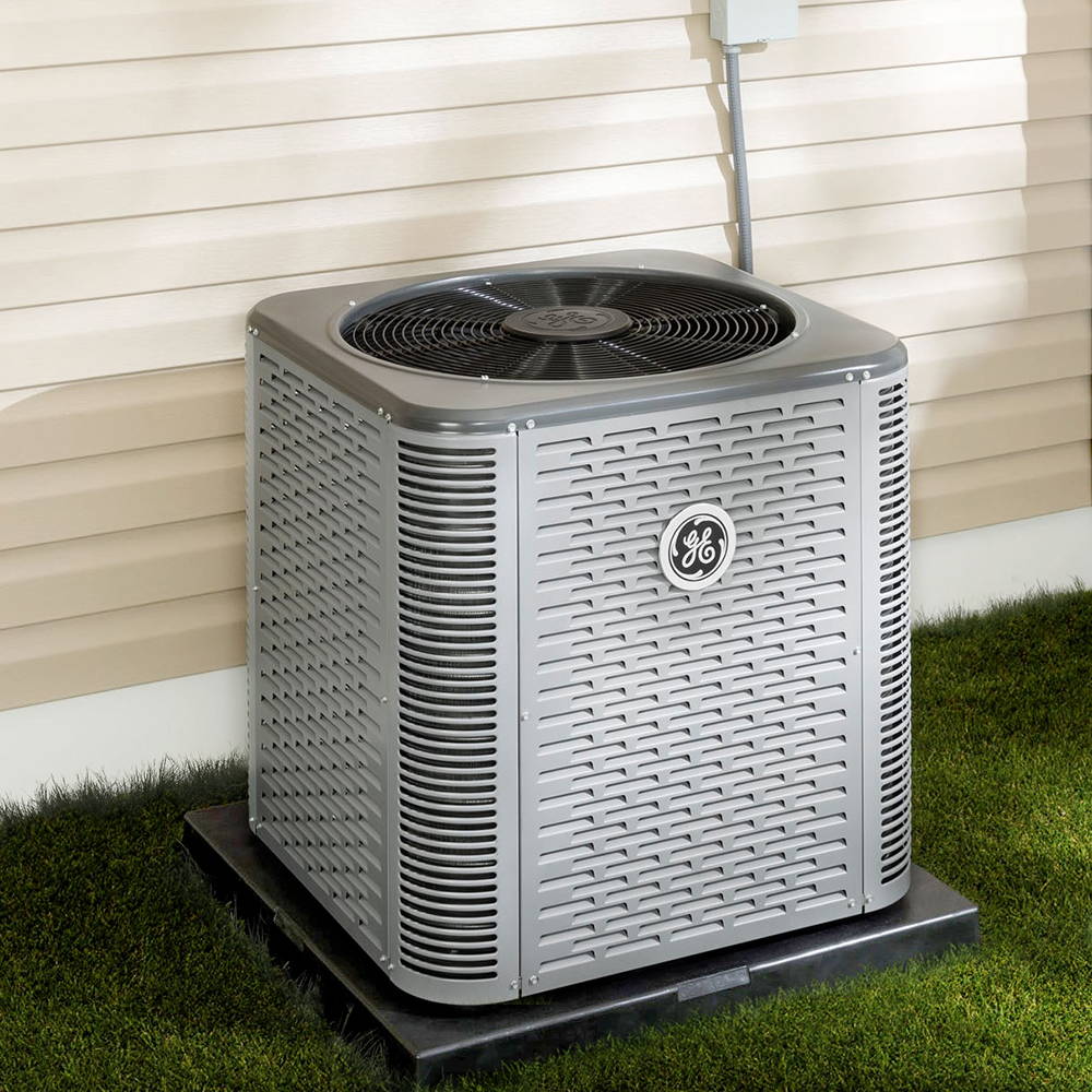 GE residential HVAC outdoor air conditioning unit installed outside a home